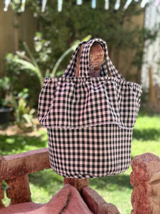Load image into Gallery viewer, Black and white checkered strollee basket  bag on a stone bench outdoors
